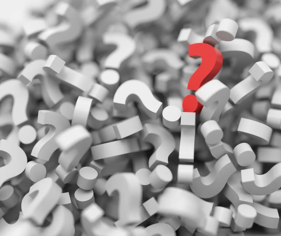 Red question mark among many white question marks