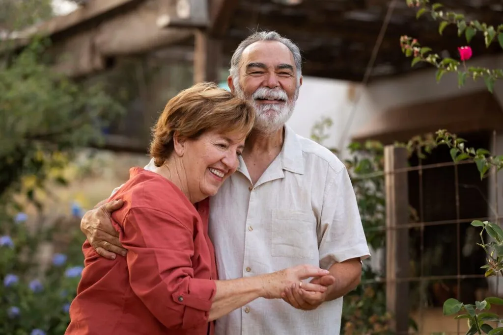 Happy senior couple embracing outdoors.