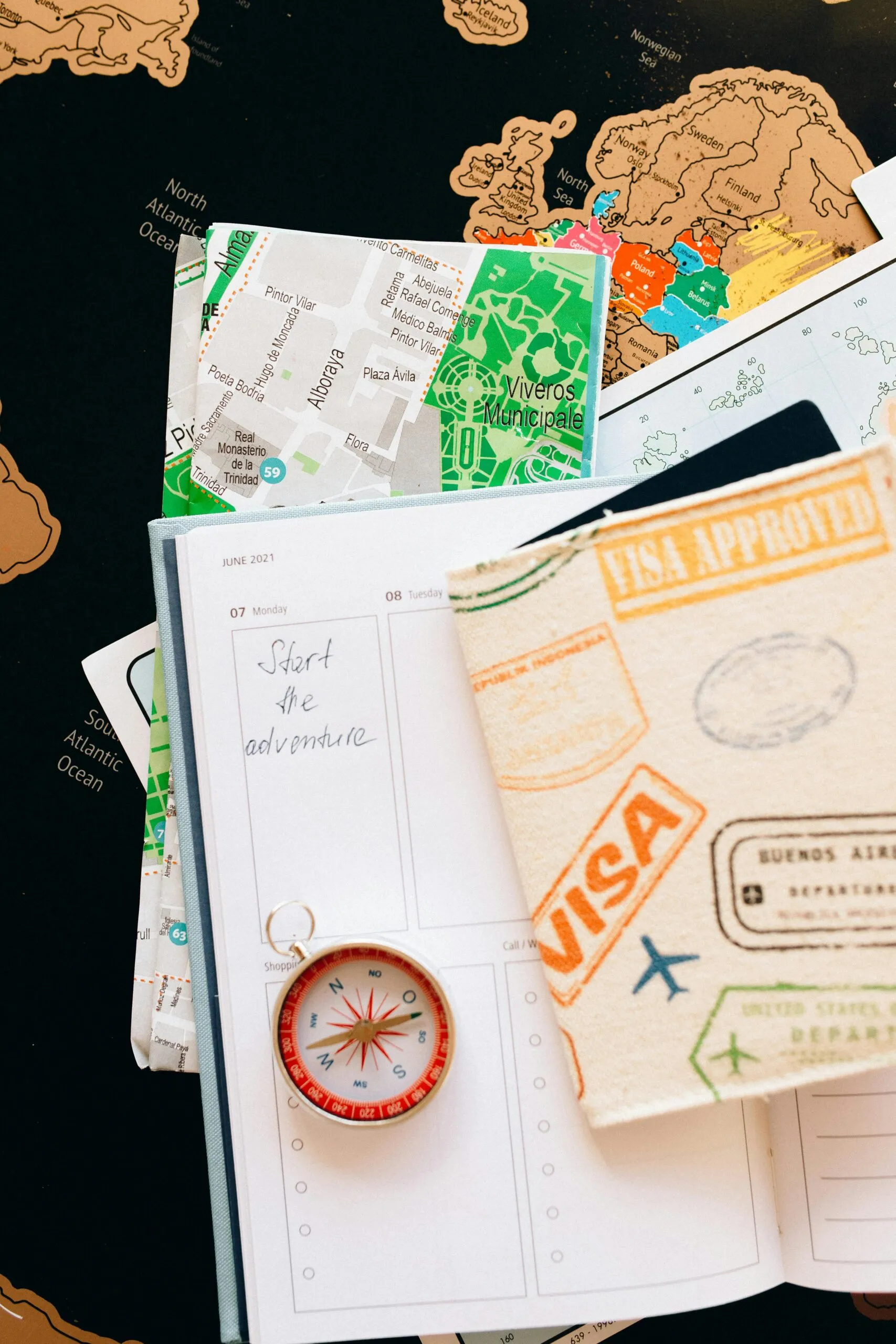 Passport with visa stamps, maps, compass, and planner; 