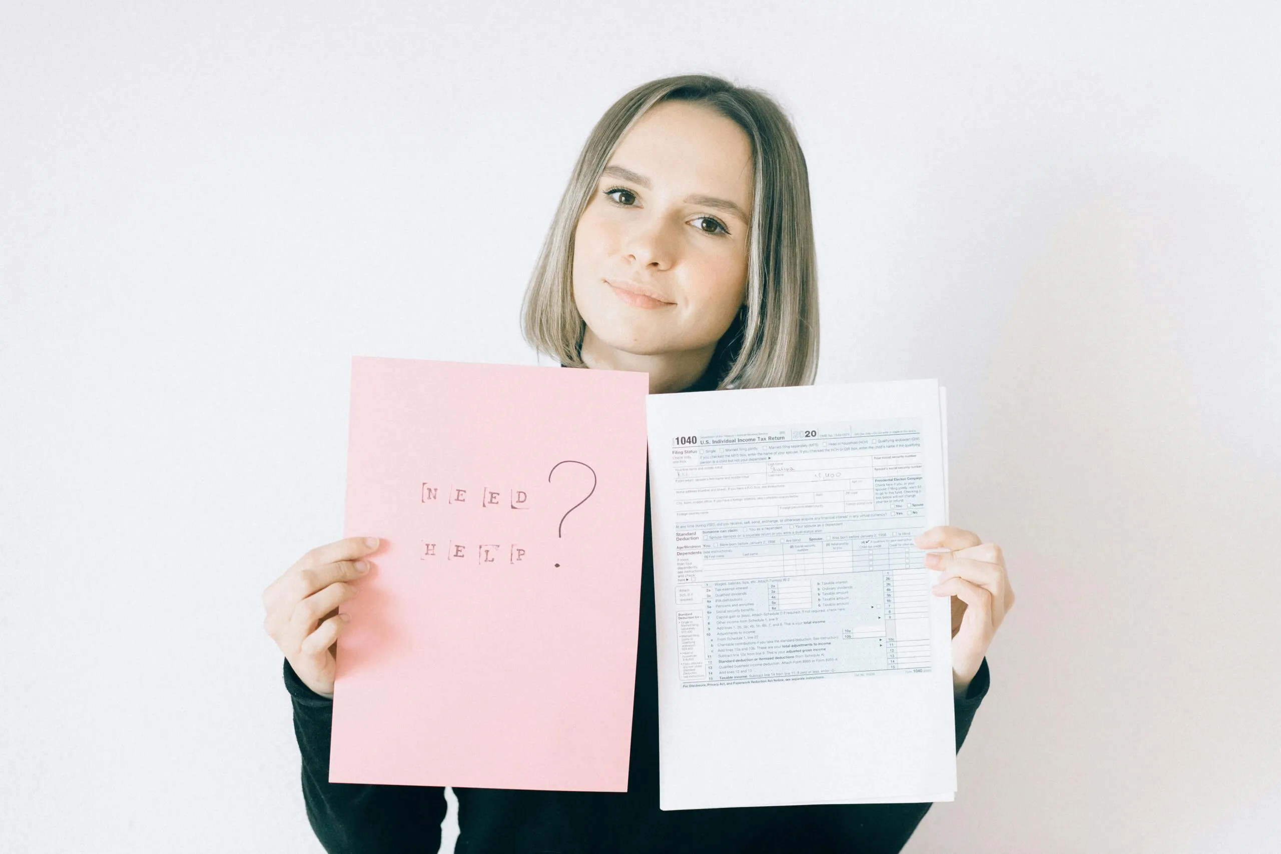 Woman holding tax form 1040 and a sign that says 