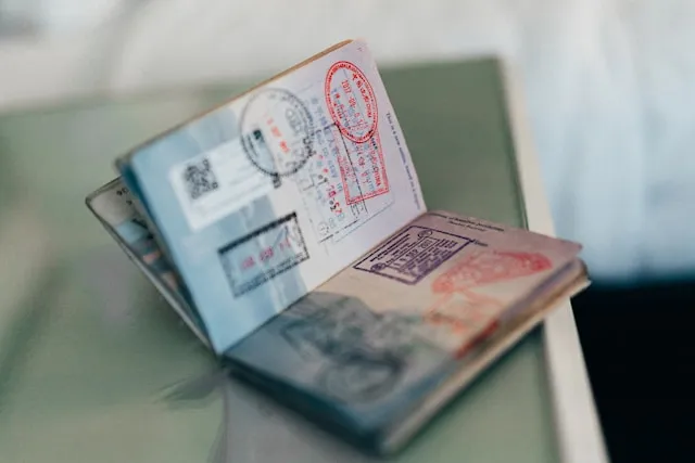 Open passport with multiple visa stamps, related to visa refusal appeal.