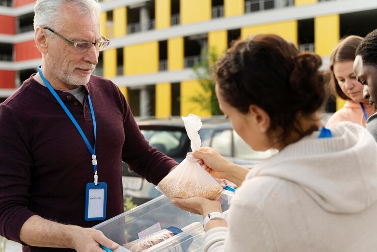 Volunteers sorting food donations at a charity. 