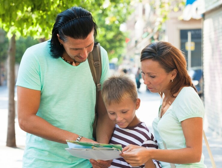 Family looking at a map while traveling.