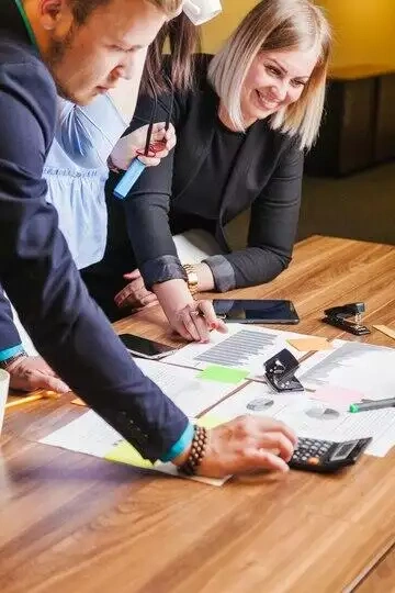 Team of professionals collaborating on financial documents at a table.