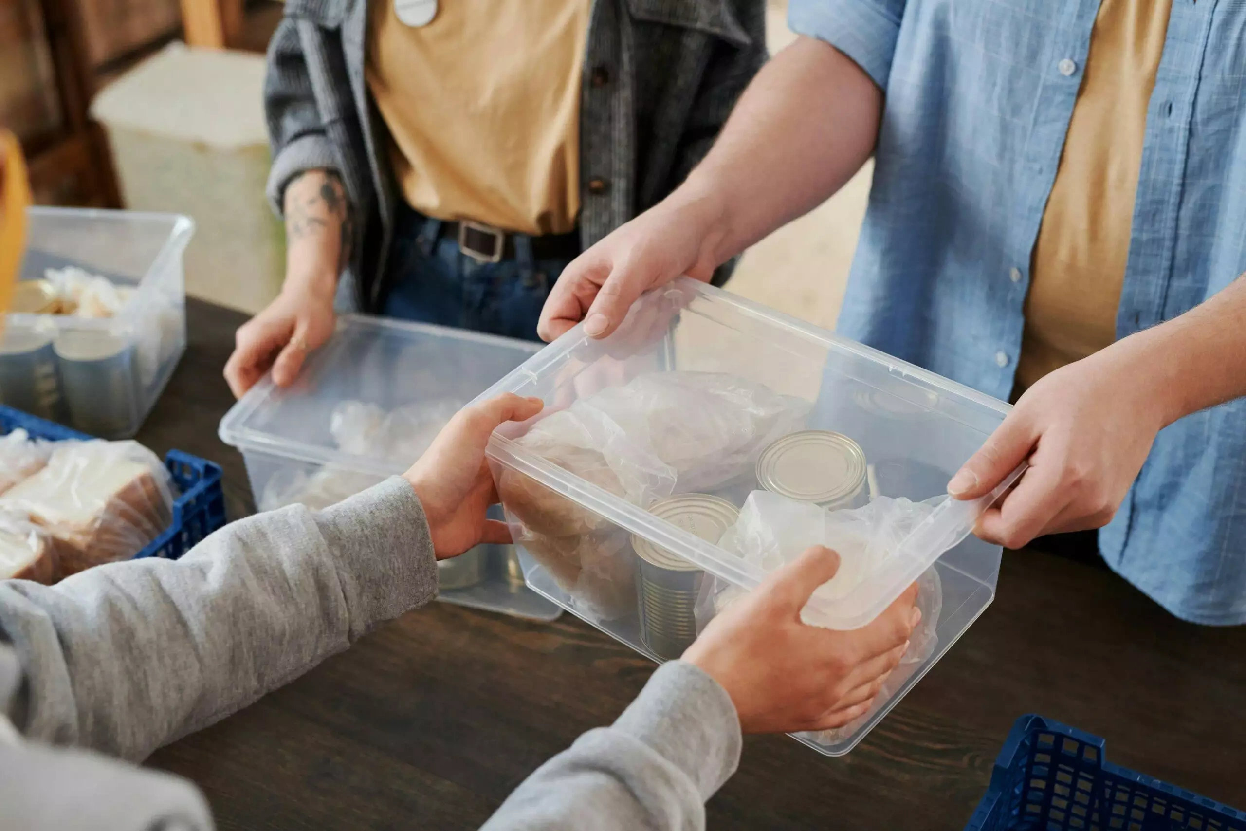 Volunteers sorting food donations into containers at a food bank.