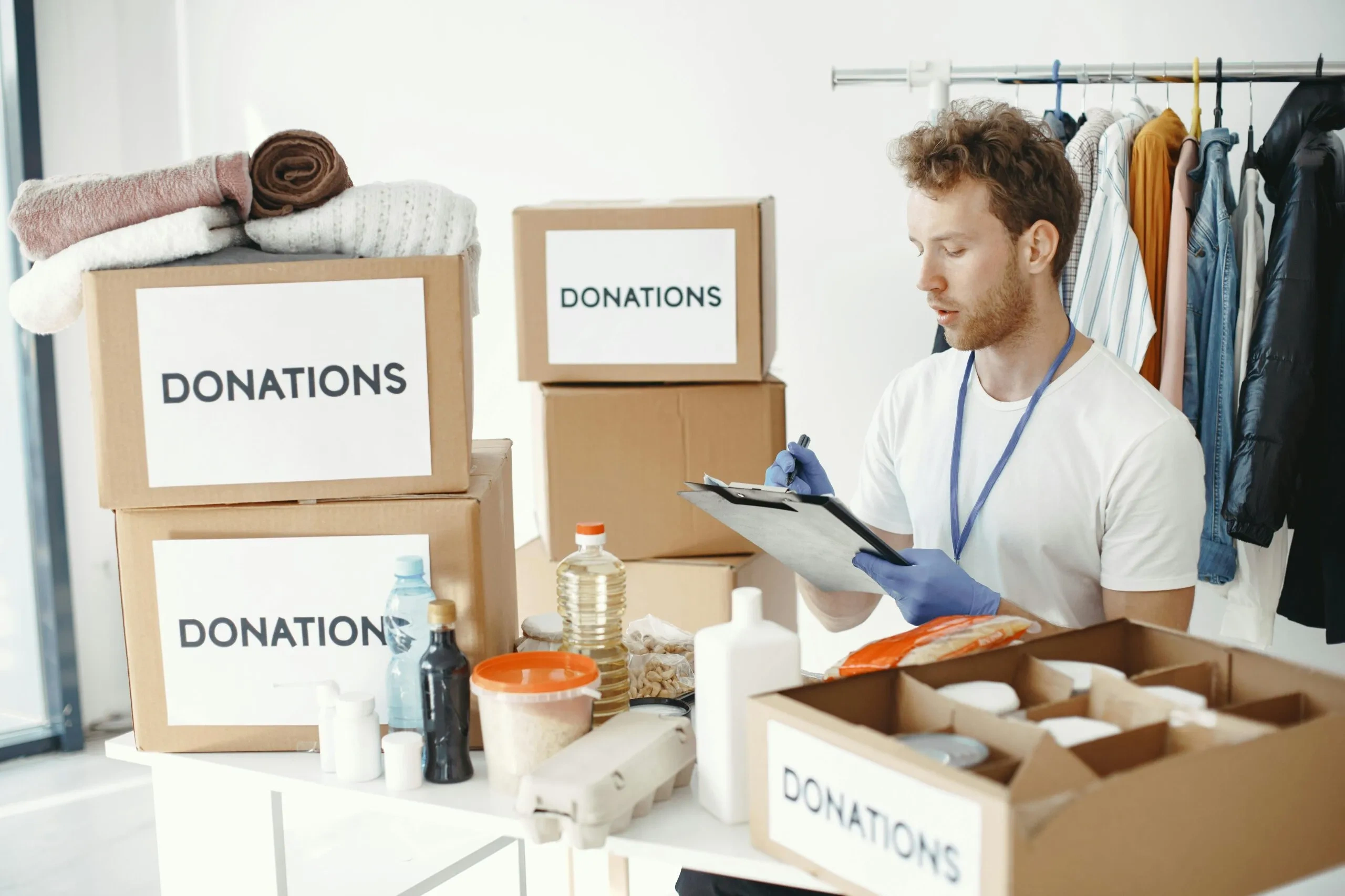 Volunteer sorting donations for an Australian charity, including boxes labeled