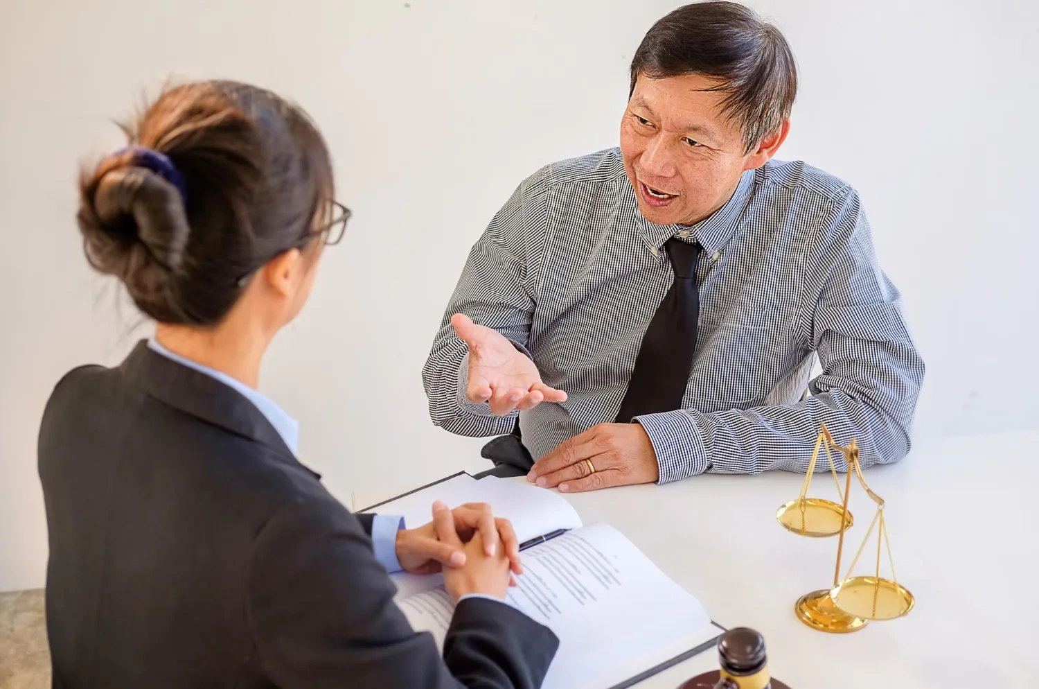Lawyer consults with client in office setting about ACNC investigation and compliance review.