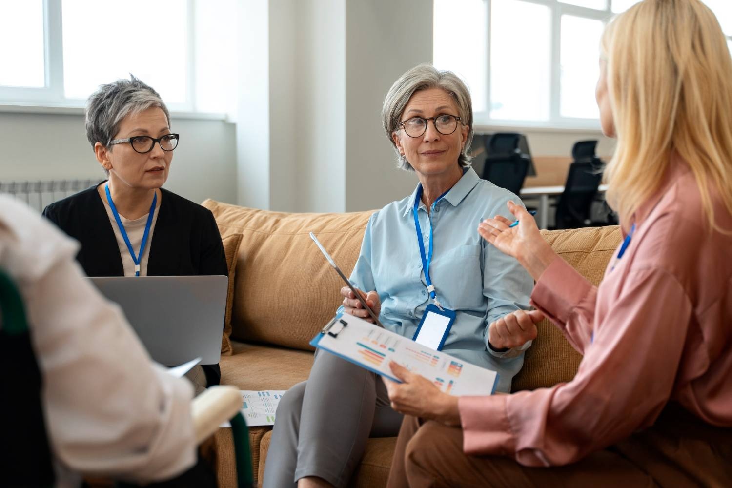 NFP team discussing contract law with charts and laptop in office.