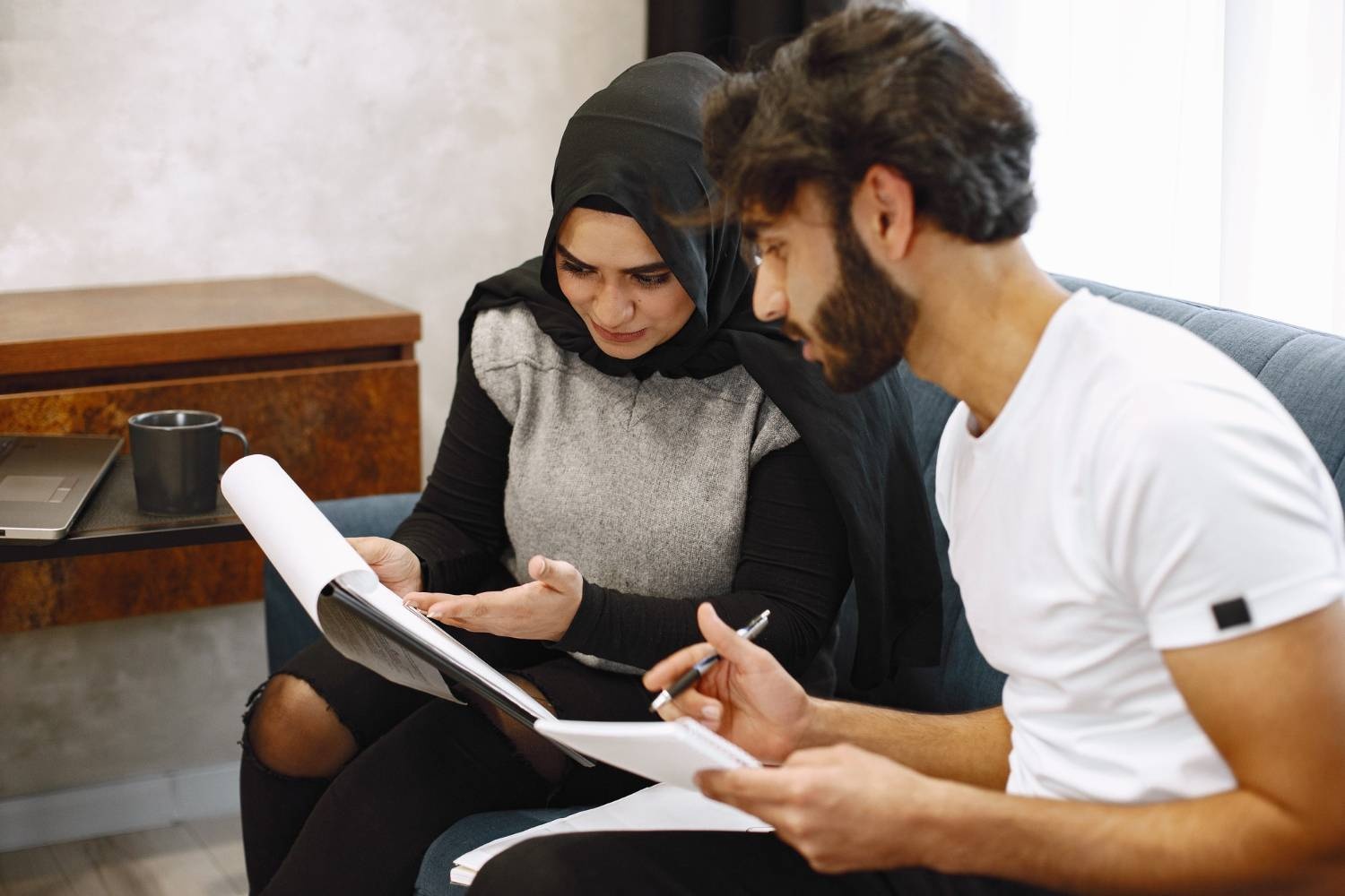 Muslim couple planning their Islamic will in Australia, reviewing documents together.