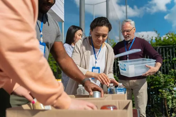 Volunteers sorting donations for charity, fulfilling charitable purpose under the Charities Act AU.
