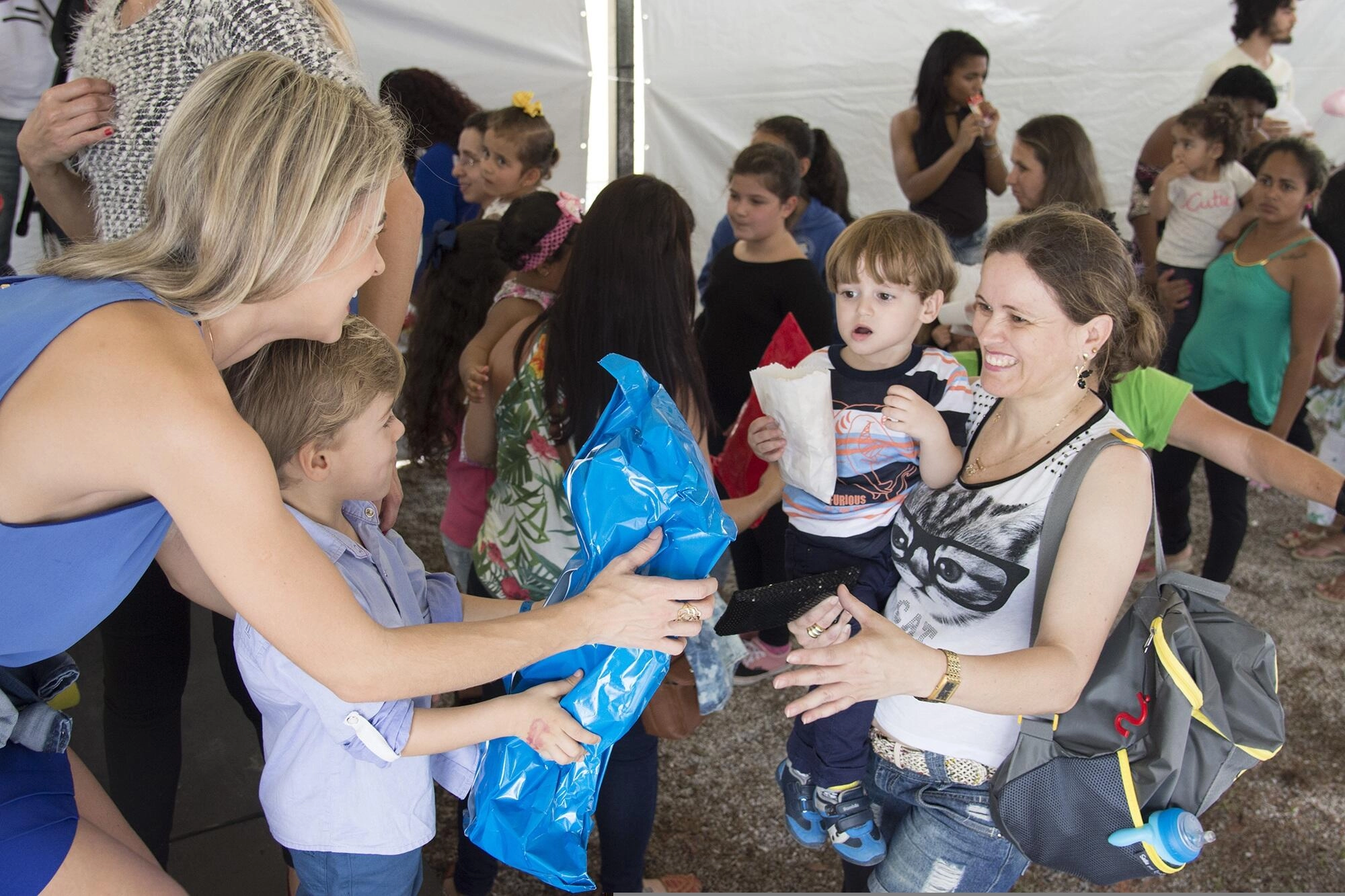 Volunteers distributing gifts to children at a charity event. Good governance ensures responsible use of donations.
