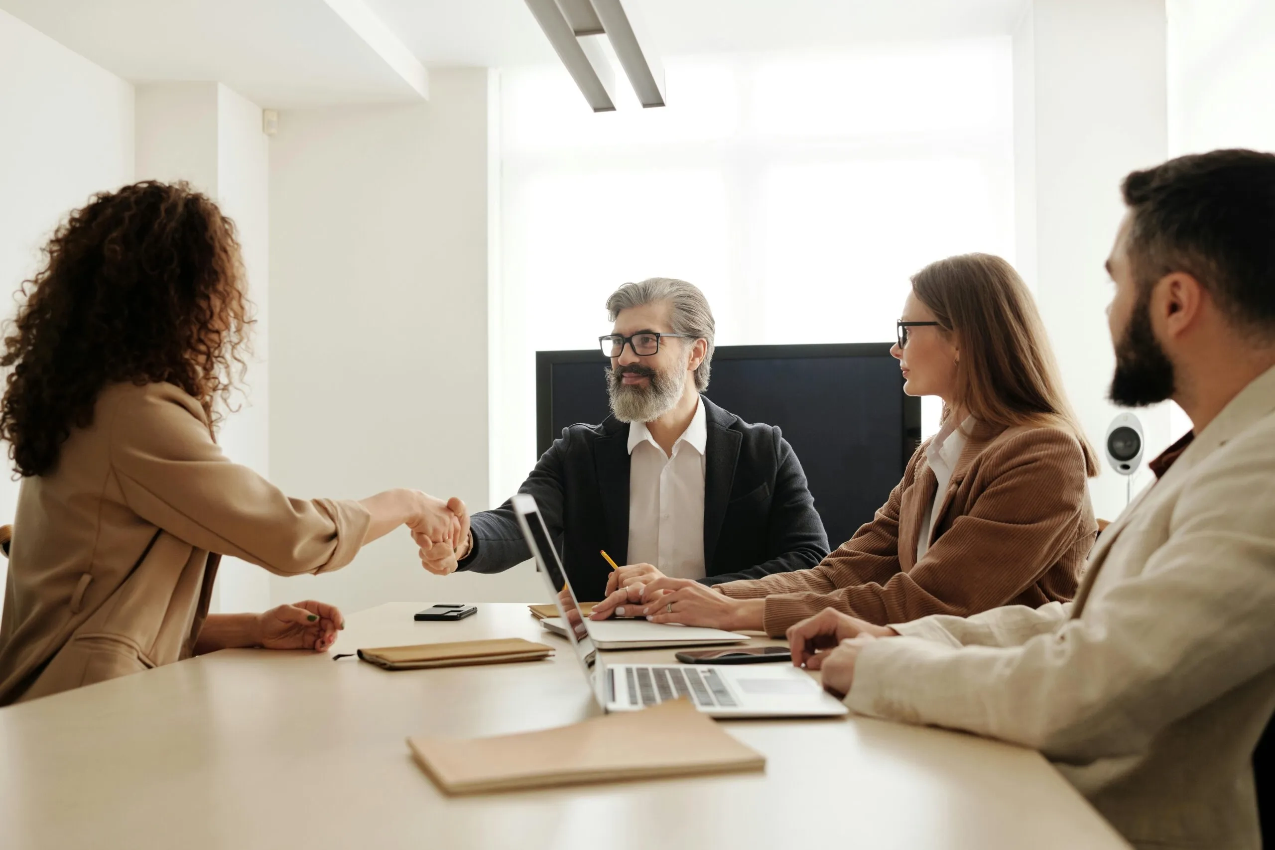 Business handshake at a board meeting. Effective charity board onboarding and NFP governance discussion.