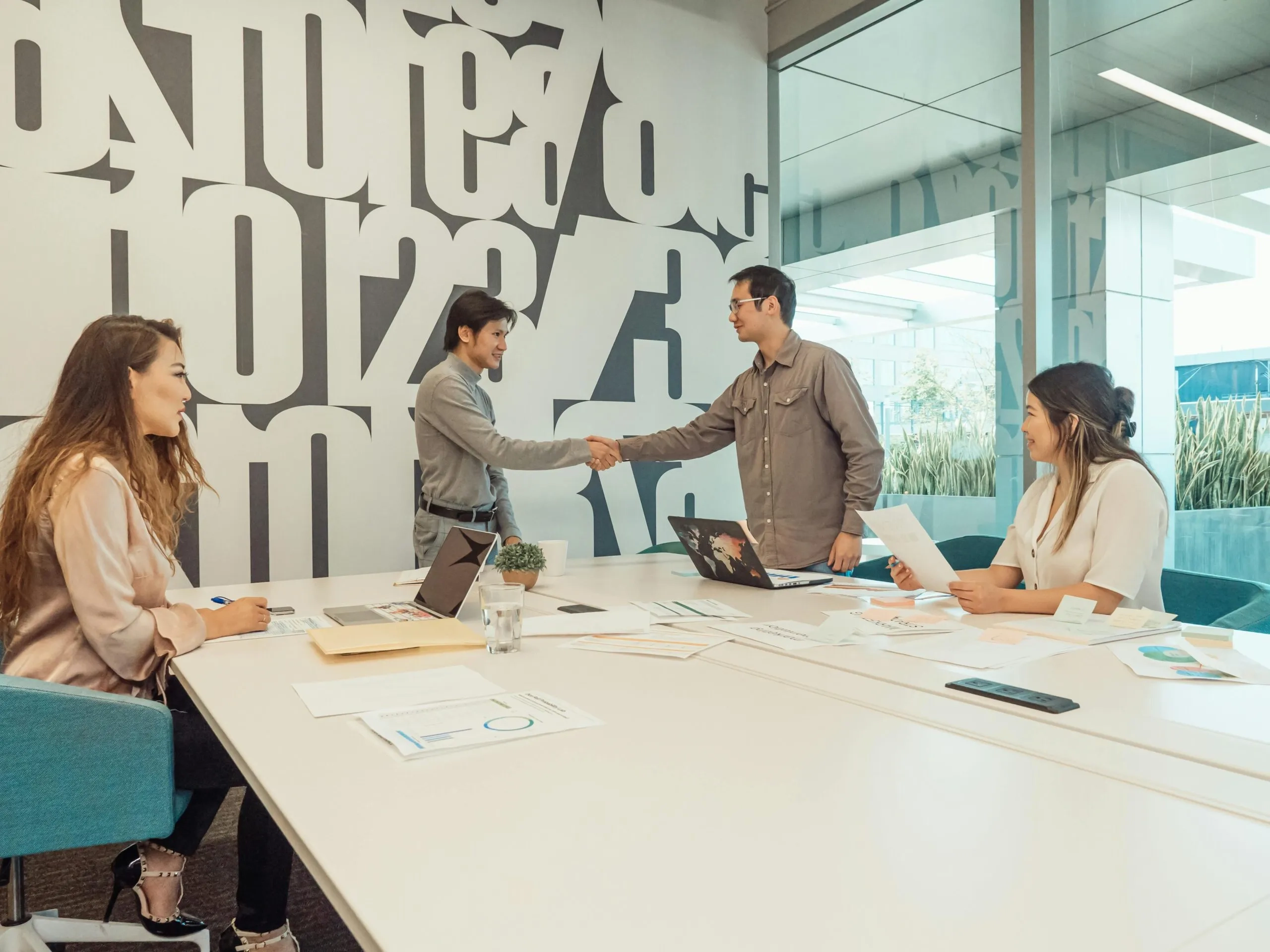 Business team shaking hands at a meeting, discussing NFP governance.