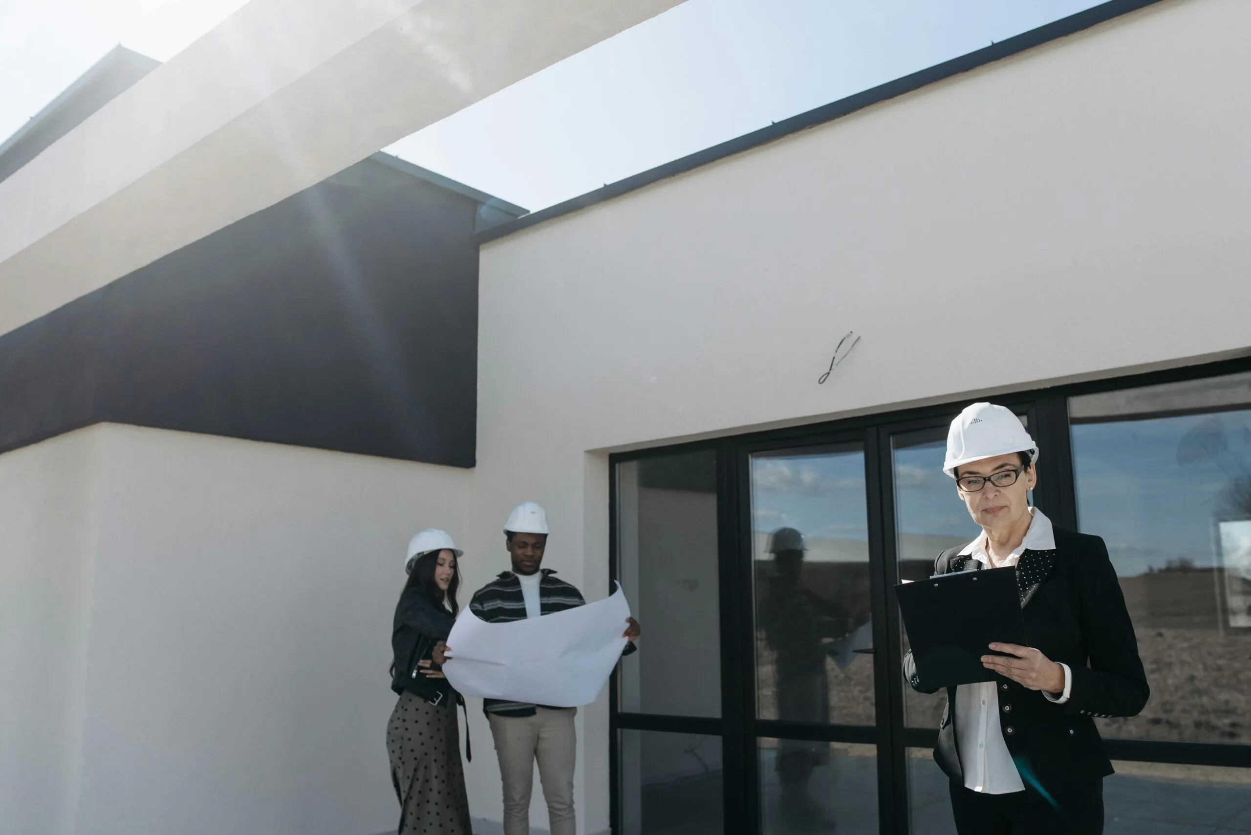 Architect reviewing blueprints on a new construction site, focusing on due diligence. NSW development.